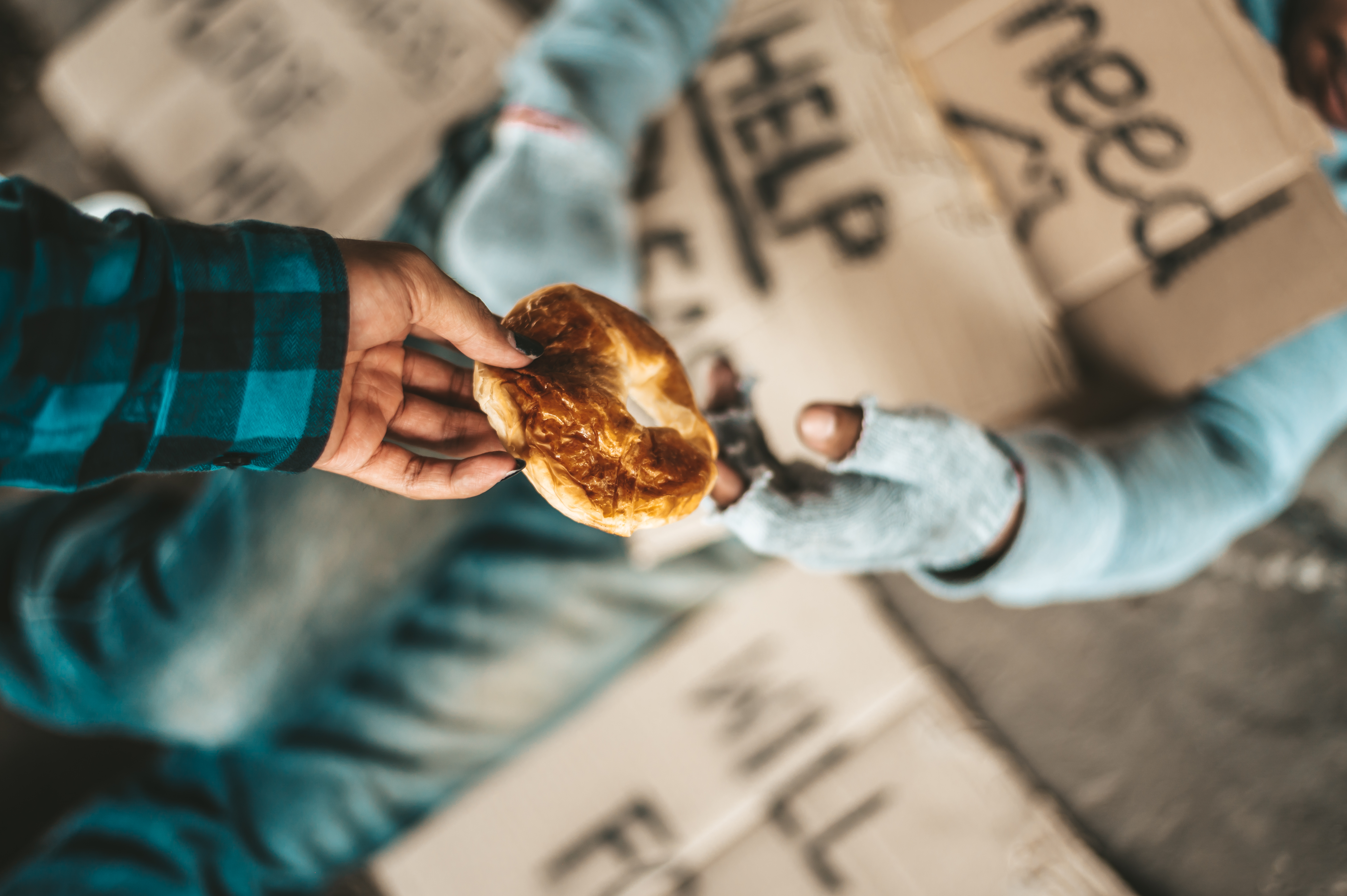 a person handing food to another hungry person